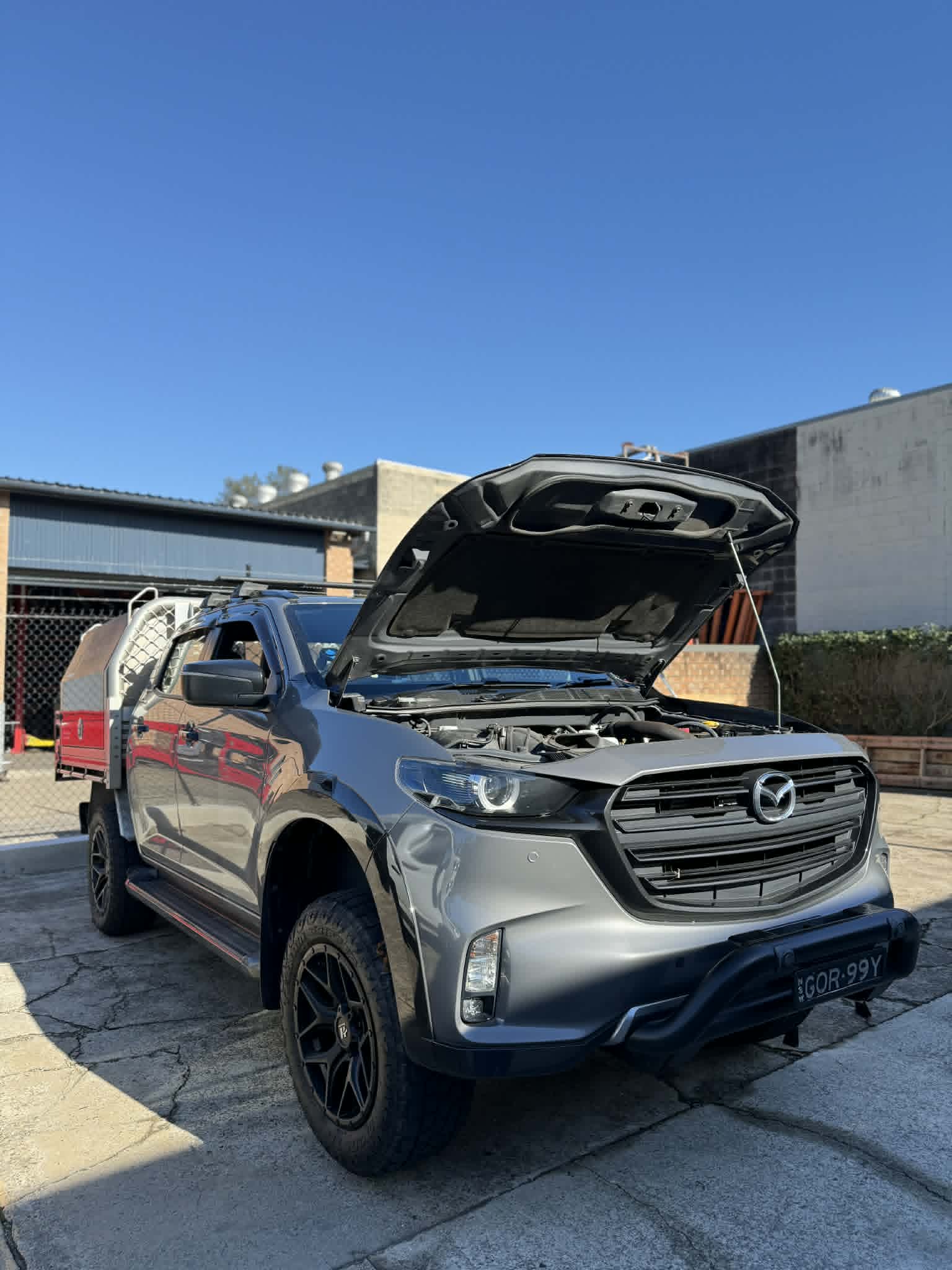 Mazda BT-50 ute with bonnet open for full log book service by On The Go Garage mobile mechanic