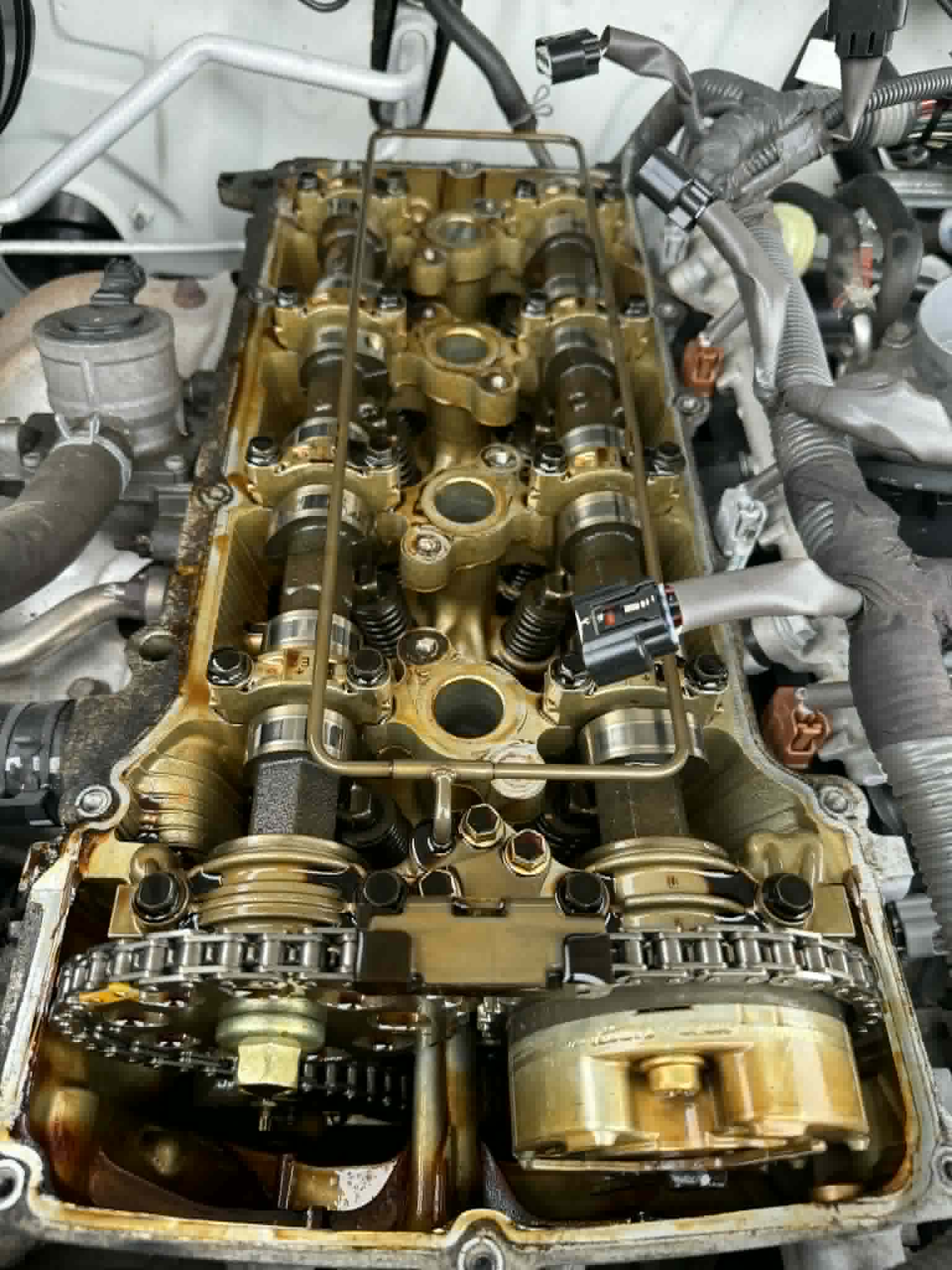Valve cover gasket replacement showing engine internals — engine repair by On The Go Garage